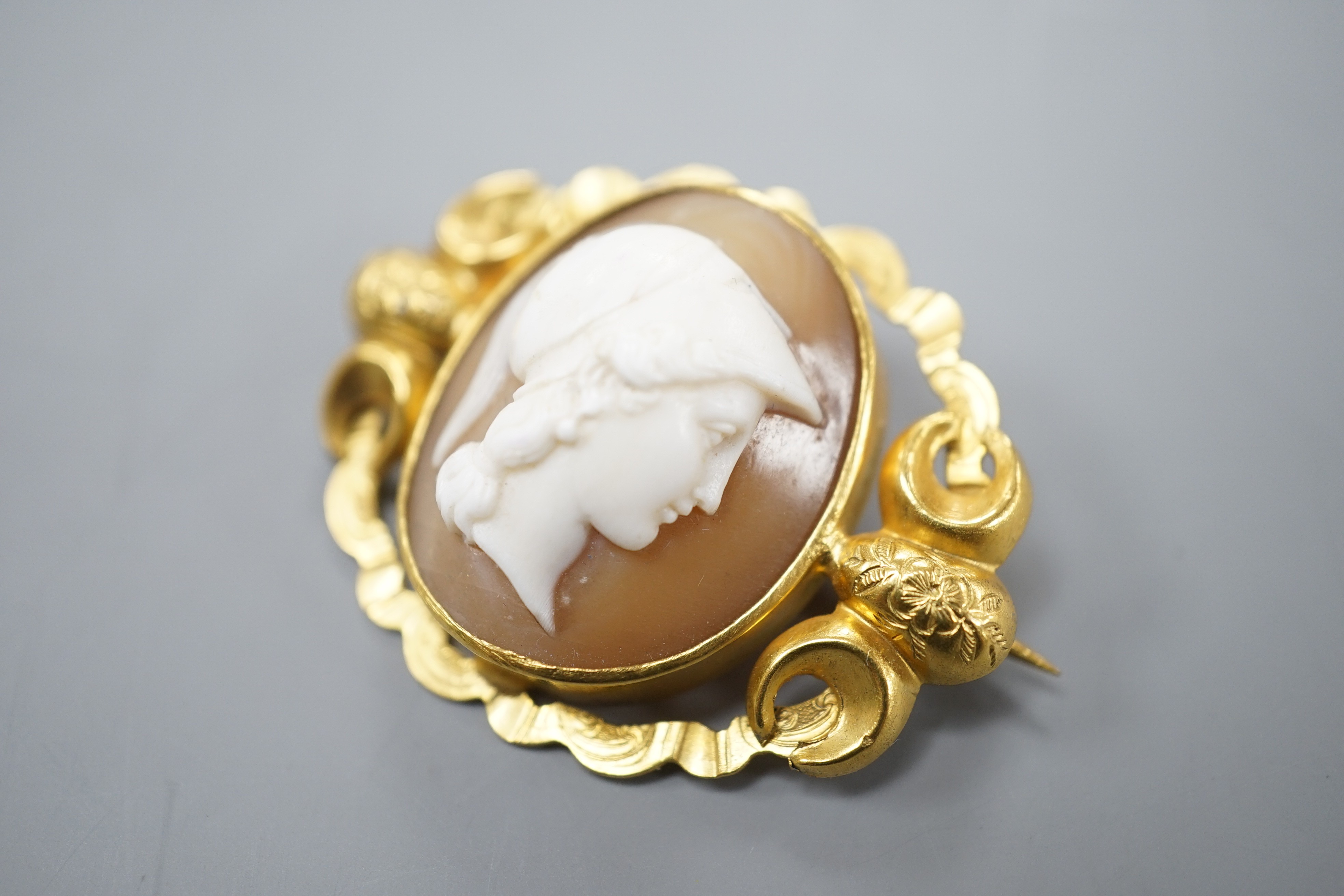 An early 20th century yellow metal mounted oval cameo shell brooch, carved with with the bust of a gentleman to sinister, 37mm, gross 7.6 grams.